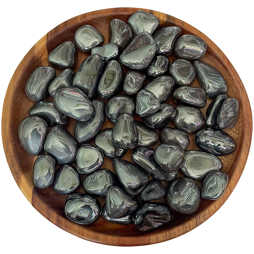A collection of hematite stones on a wood plate.