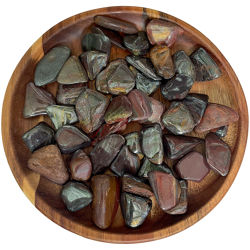 A collection of mugglestone crystals on a wood plate.