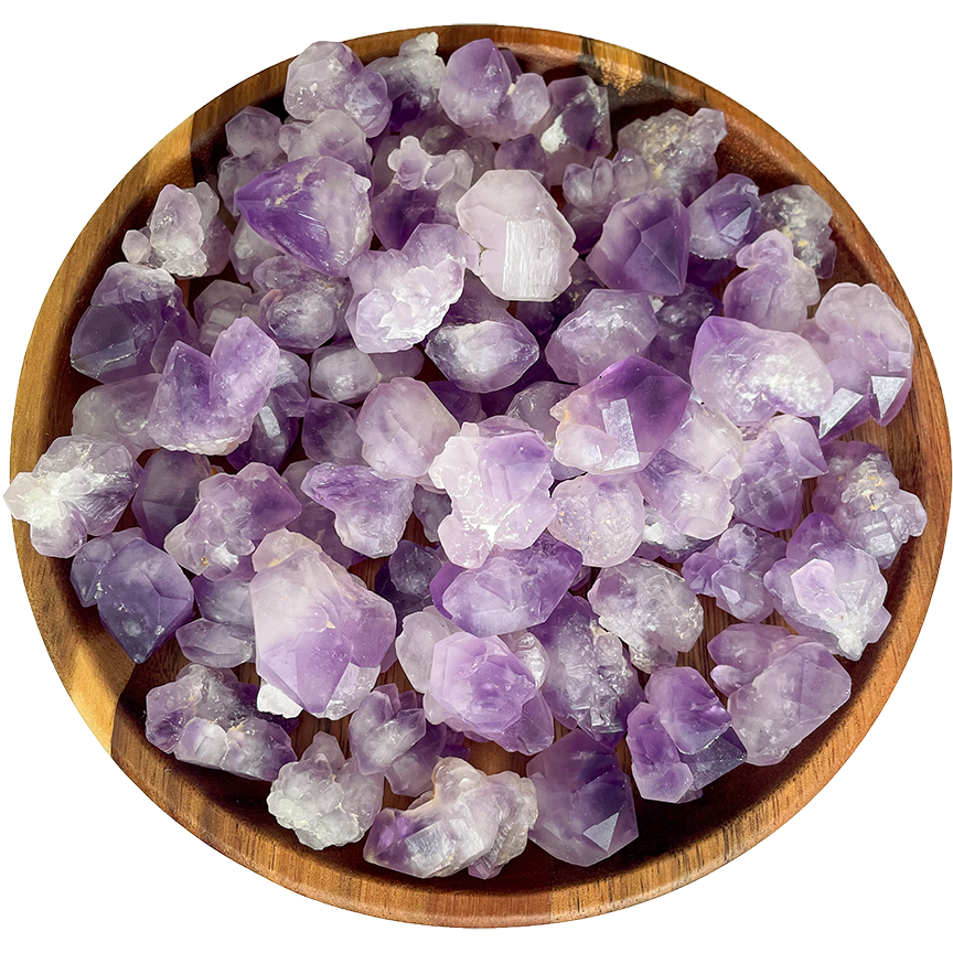 A collection of popcorn amethyst crystals on a wooden plate.