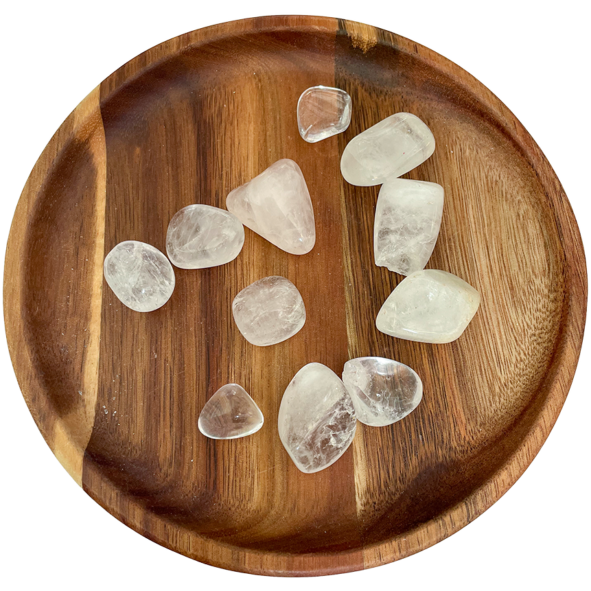 A collection of topaz crystals on a wooden plate.