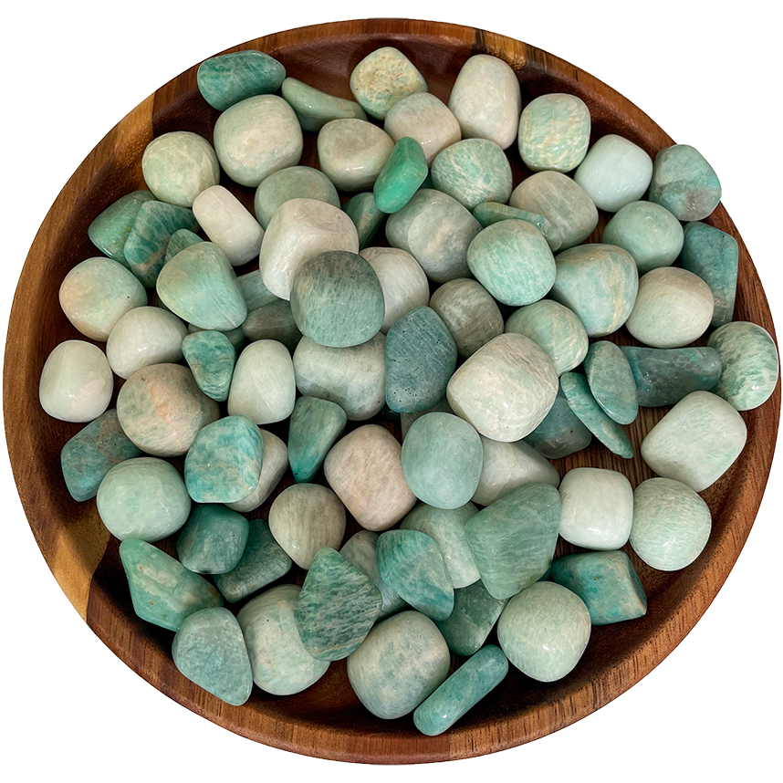 A pile of Amazonite stones on a wooden plate.