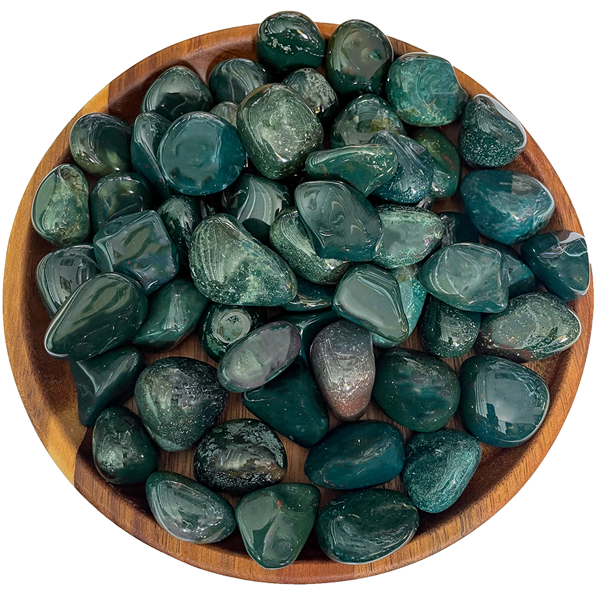 A collection of bloodstone crystals on a wooden plate.