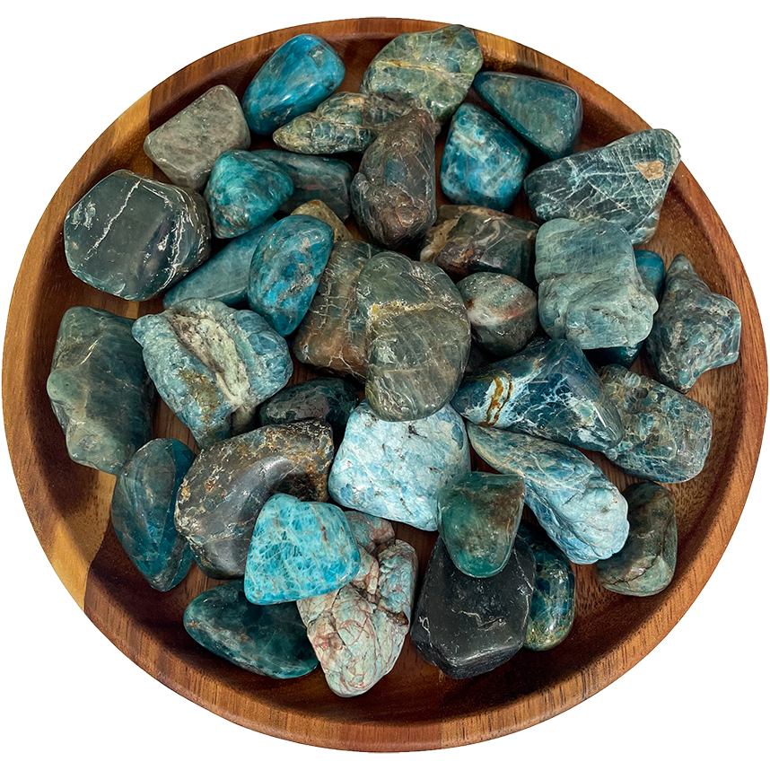 A collection of blue apatite stones on a wooden plate.