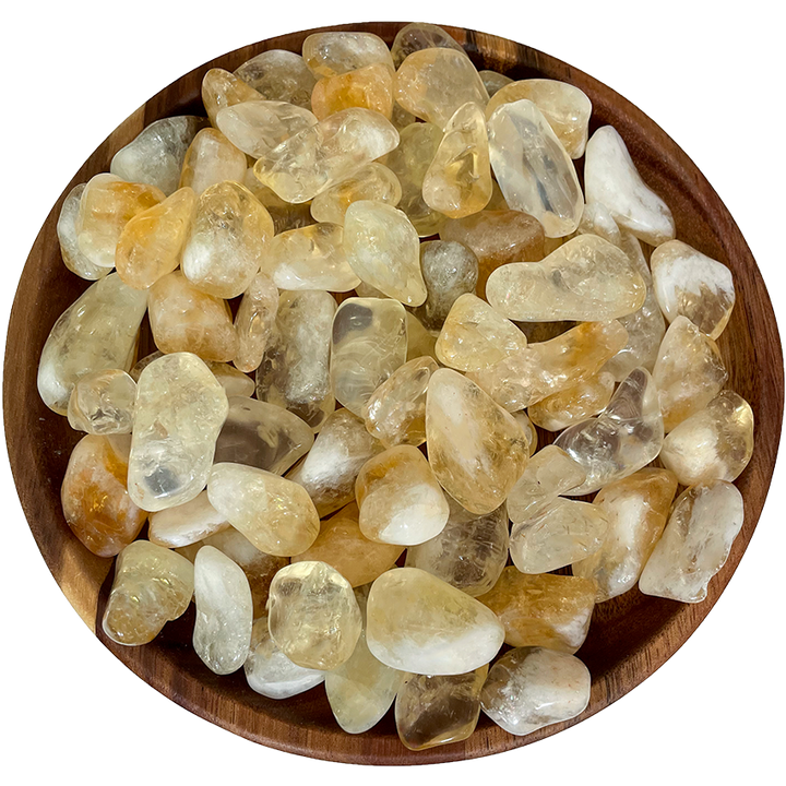 A collection of citrine crystals on a wood plate.