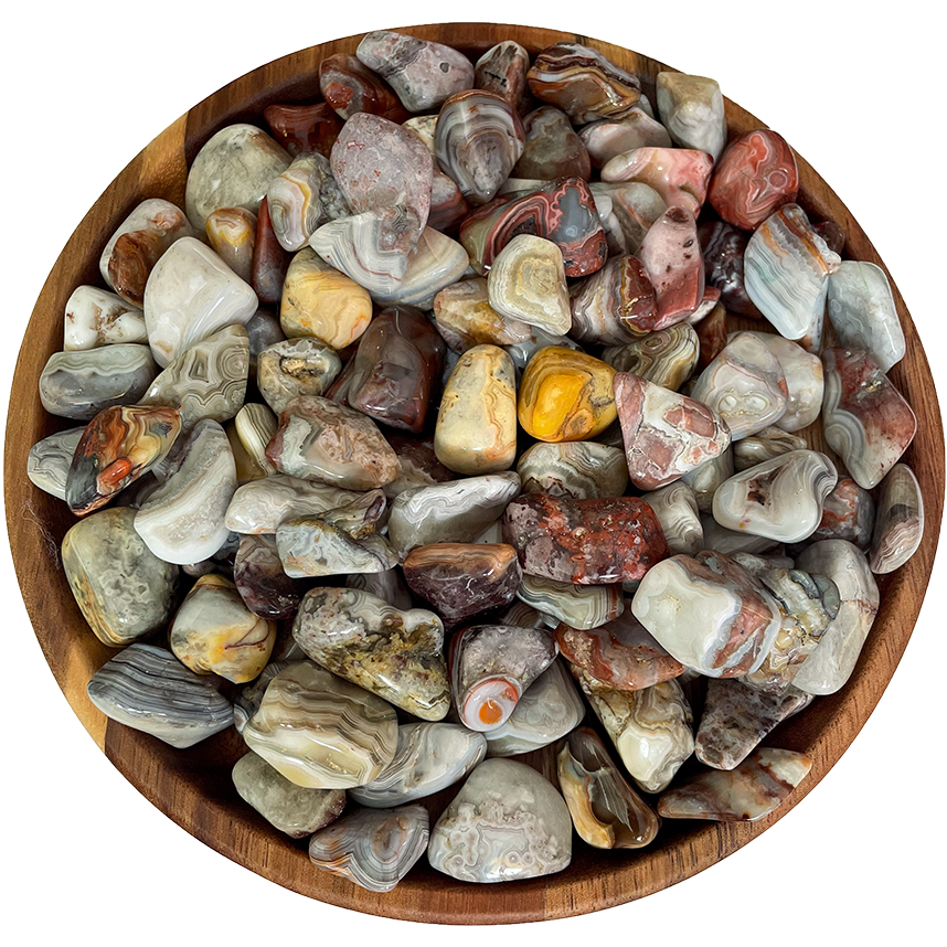 A collection of crazy lace agate stones on a wooden plate.