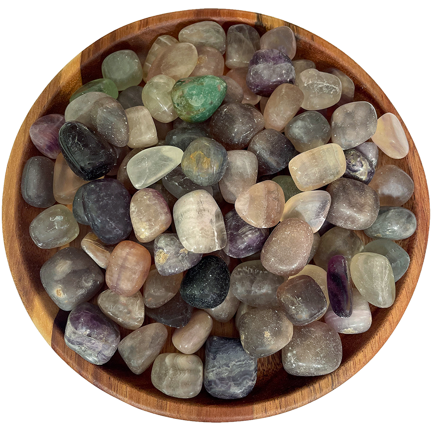 A collection of fluorite crystals on a wooden plate.