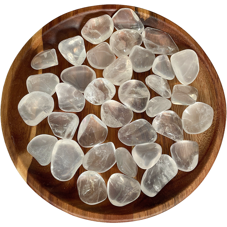A collection of girasol quartz crystals on a wooden plate.