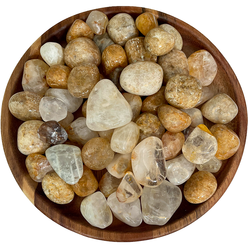A collection of golden healer quartz on a wood plate.