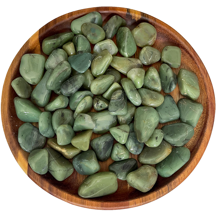 A collection of green chalcedony stones on a wooden plate.