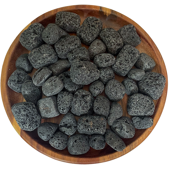A collection of lava stone on a wood plate.
