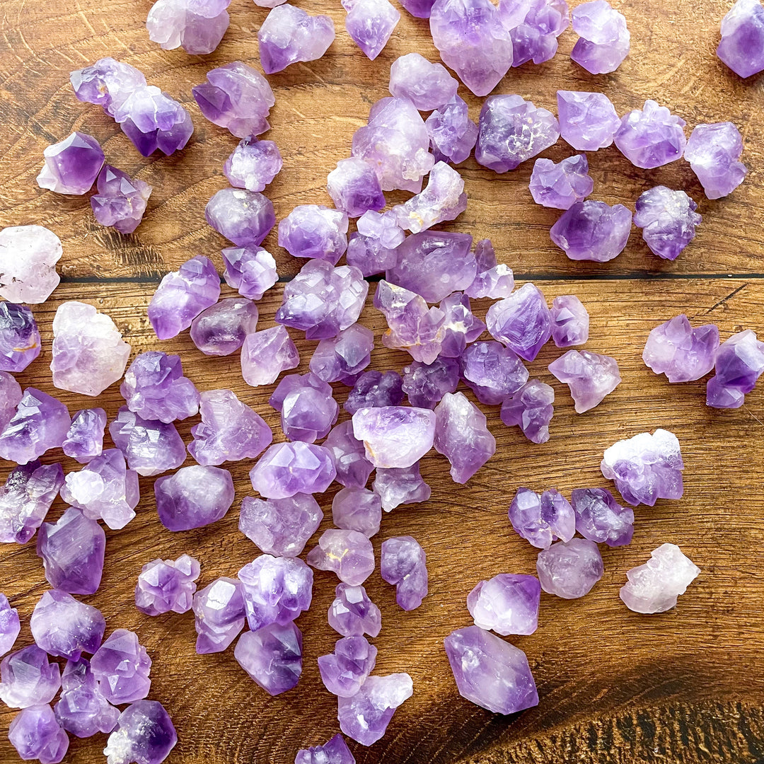 Pieces of popcorn amethyst on a wooden background.