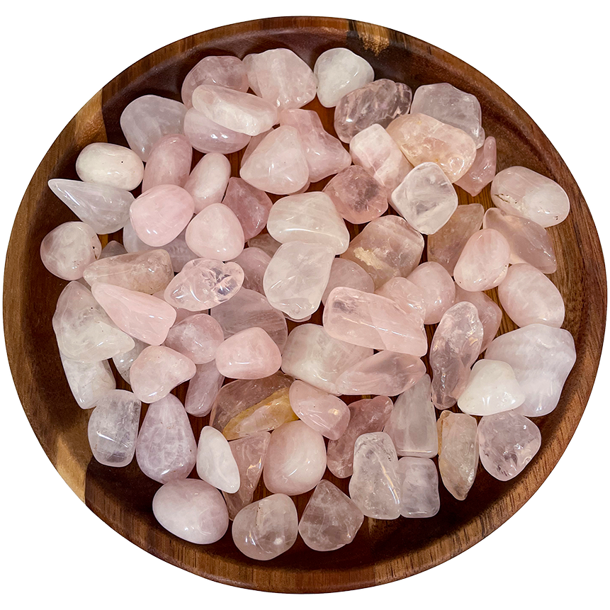 A collection of rose quartz crystals on a wood plate.