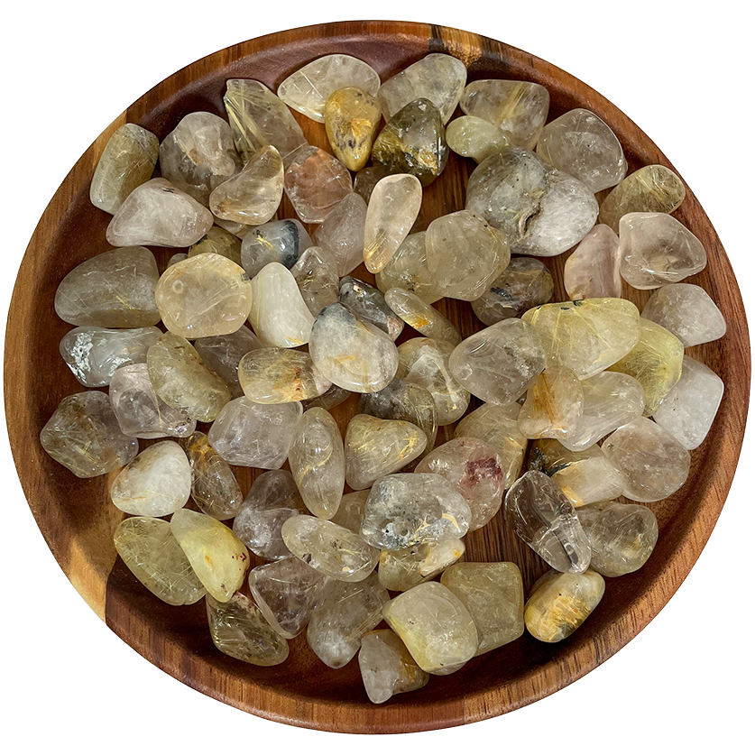 A collection of rutilated quartz crystals on a wooden plate.