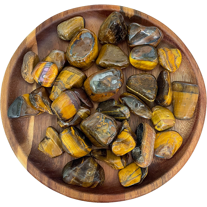 A collection of tiger's eye stones on a wood plate.