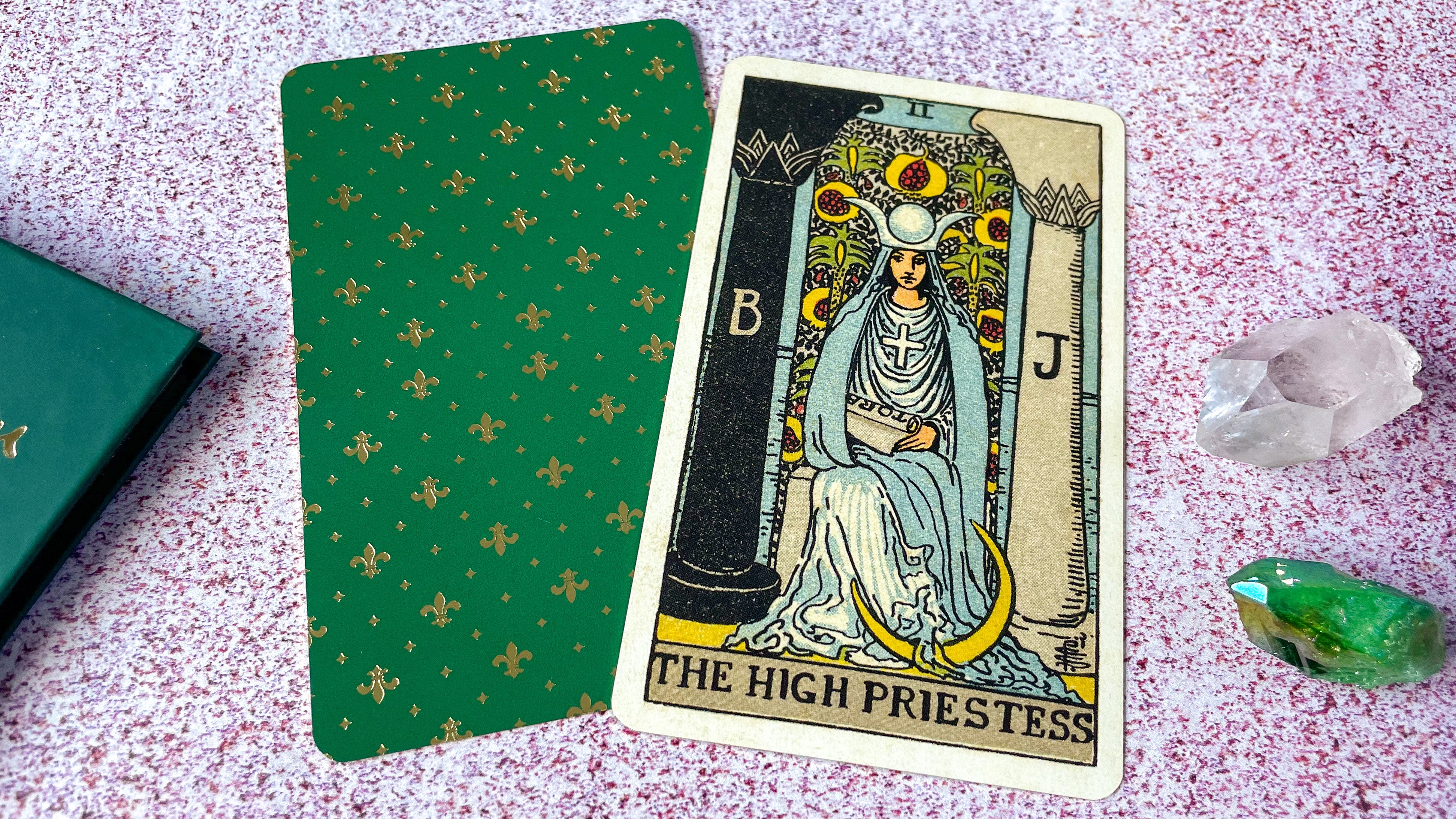 The traditional Rider-Waite High Priestess tarot card laying flat.